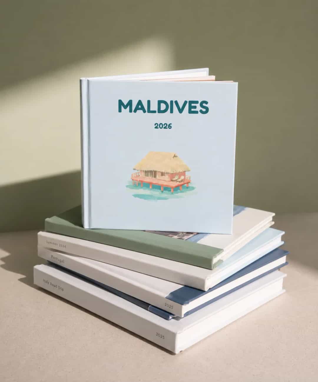 Illustrated travel photo book cover concepts showing Amsterdam, Kyoto and a Greek harbour