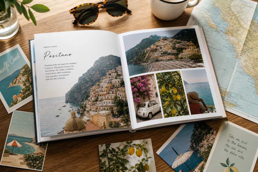 Open travel photo book with postcards and map