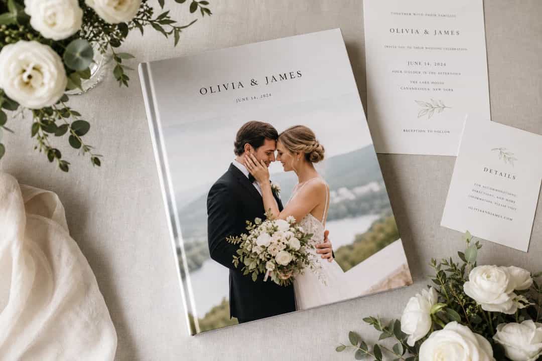 Elegant wedding photo book with flowers and invitation cards